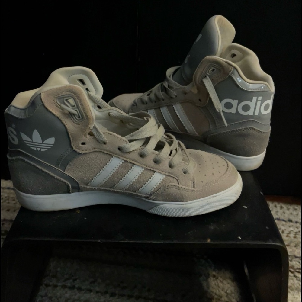 Gray adidas hightops.